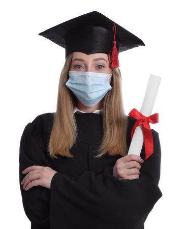 Student in protective mask with diploma on white backgroundの写真素材