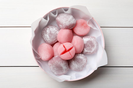 Many different delicious mochi in box on white wooden table, top view. Traditional Japanese dessertの写真素材