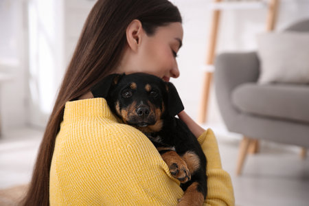 Woman with cute puppy indoors. Lovely petの写真素材