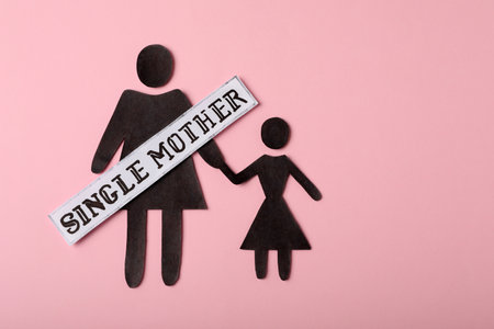 Being single mother concept. Woman with her child made of paper on pink background, flat lay and space for textの写真素材