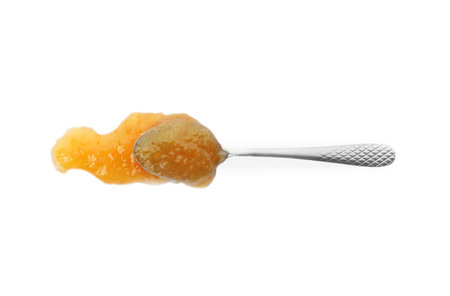 Delicious orange marmalade and spoon on white background, top viewの写真素材