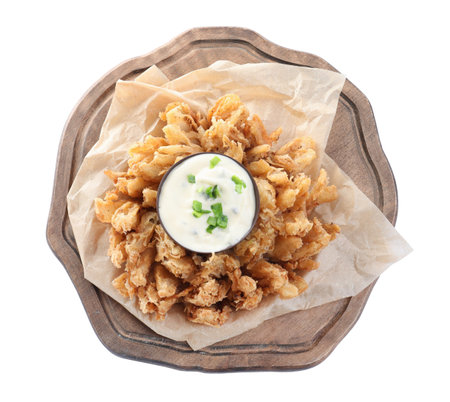 Wooden board with fried blooming onion and sauce isolated on white, top viewの写真素材