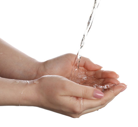 Pouring water into woman's hands on white background, closeupの写真素材