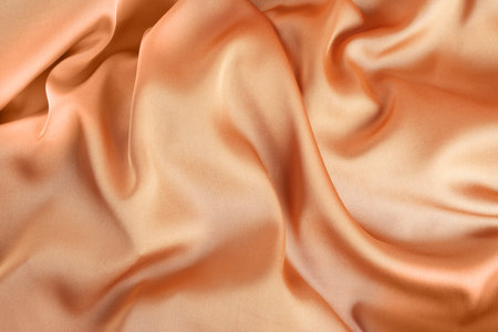 Texture of peach silk as background, above viewの写真素材