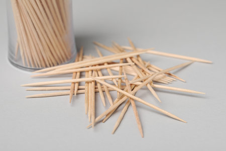 Disposable wooden toothpicks on gray background, closeupの写真素材