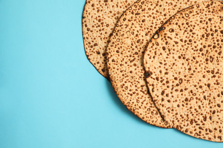 Tasty matzos on light blue background, flat lay with space for text. Passover (Pesach) celebrationの写真素材
