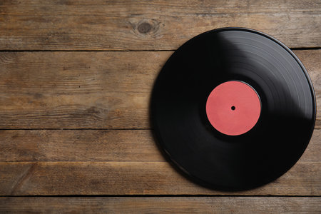 Vintage vinyl record on wooden background, top view. Space for textの写真素材
