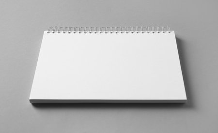 Blank notebook on gray background. Mockup for designの写真素材