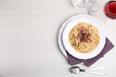 Delicious Carbonara pasta served on white wooden table, flat lay. Space for textの写真素材