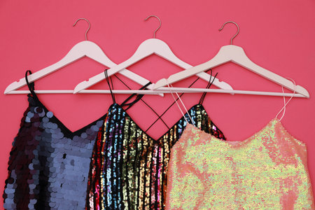 Collection of women's garments on pink background, flat lay. clothes rent conceptの写真素材