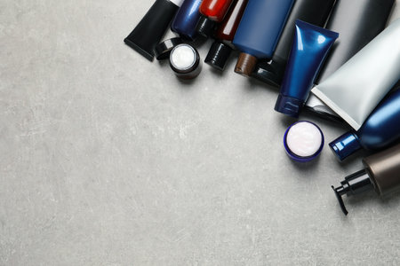 Facial cream and other men's cosmetic on light gray stone table, flat lay. Mockup for designの写真素材