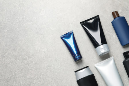 Facial cream and other men's cosmetic on light gray stone table, flat lay. Mockup for designの写真素材