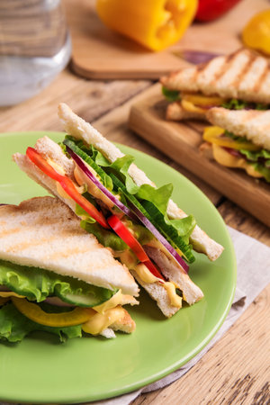 Green plate with tasty sandwiches on wooden table, closeup. Space for textの写真素材