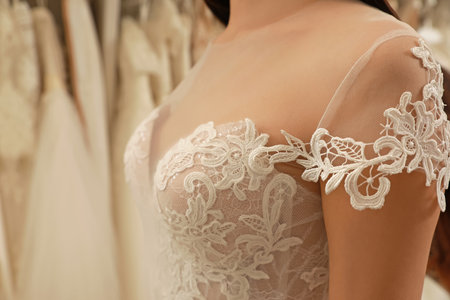 Woman trying on wedding dress in boutique, closeupの写真素材