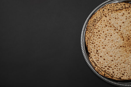 Tasty matzos on black background, top view with space for text. Passover (Pesach) celebrationの写真素材