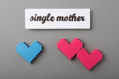 Hearts and text Single mother on gray background, flat layの写真素材