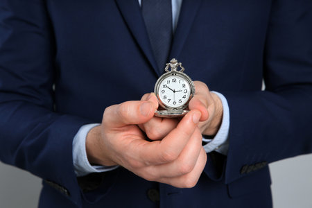 Businessman holding pocket watch, closeup. time managementの写真素材