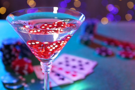 Cocktail with casino dice in glass on table, closeup. Space for textの写真素材