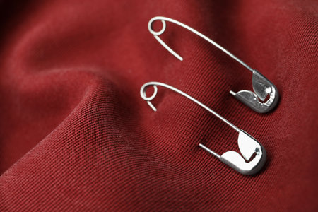 Closeup view of metal safety pins on clothingの写真素材