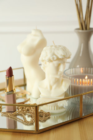David bust and female body shaped candles on wooden table. Stylish decorの写真素材