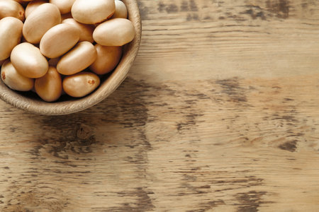 Raw jackfruit seeds on wooden table, top view. Space for textの写真素材