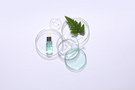 Organic cosmetic product, natural ingredient and laboratory glassware on white background, top viewの写真素材