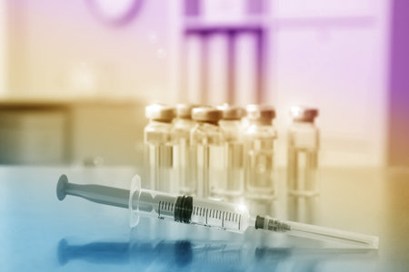 Syringe and vials with medicine on table indoorsの写真素材
