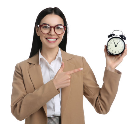 Businesswoman holding alarm clock on white background. Time managementの写真素材
