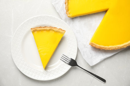 Delicious homemade lemon pie on light gray marble table, flat layの写真素材