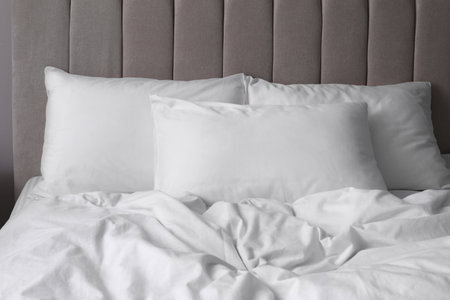 White soft pillows on comfortable bed indoorsの写真素材
