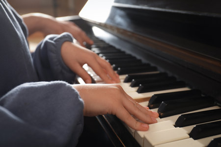 Little child playing piano, closeup. music lessonsの写真素材