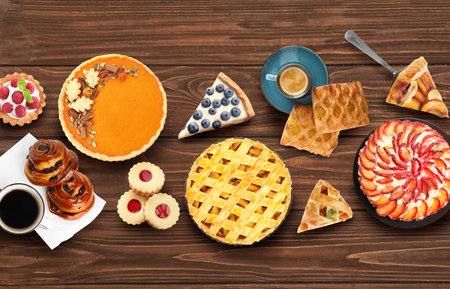 Flat lay composition with different delicious pies on wooden tableの写真素材