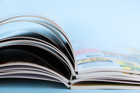 Stack of magazines on light blue background, closeupの写真素材