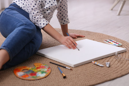 Woman artist drawing picture on canvas indoors, closeupの写真素材
