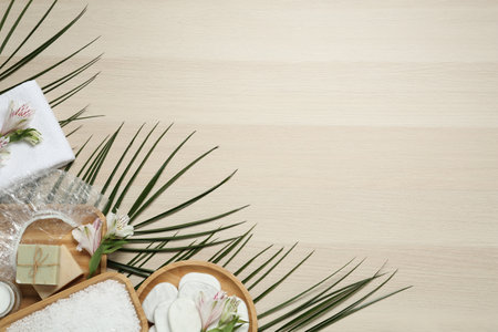 Flat lay composition with shower cap and spa stones on wooden background. Space for textの写真素材