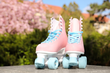 Stylish pink roller skates outdoors on sunny dayの写真素材