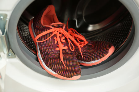Clean sports shoes in washing machine drum, closeupの写真素材