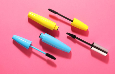 Different mascaras on bright pink background, flat layの写真素材