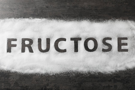 Word Fructose made of sugar on black table, top viewの写真素材