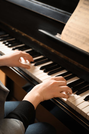 Young woman playing piano, closeup. music lessonsの写真素材