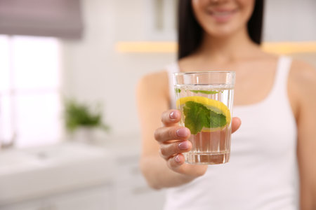 Young woman with glass of fresh lemonade at home, closeupの写真素材