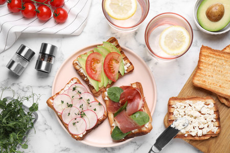 Different tasty sandwiches served on white marble table, flat layの写真素材