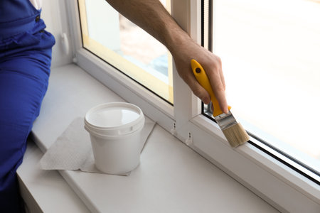 Man painting window frame at home, closeupの写真素材
