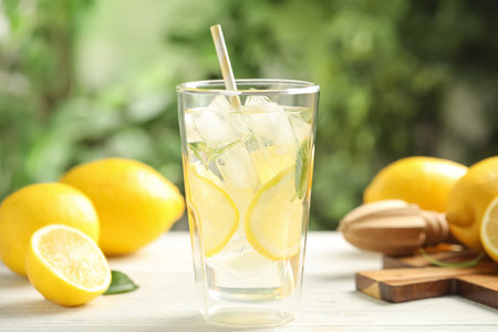 Cool freshly made lemonade and fruits on white wooden table, closeupの写真素材