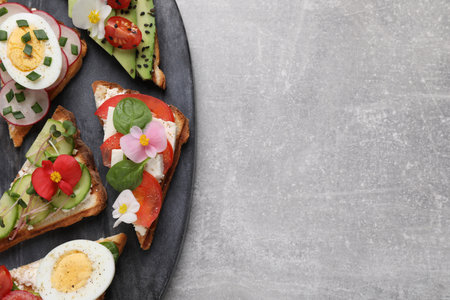 Different tasty sandwiches served on gray table, top view. Space for textの写真素材