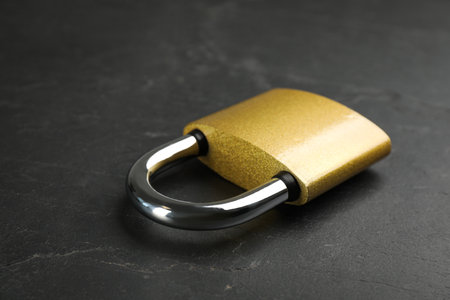Modern padlock on black table, closeup. Safety and protectionの写真素材