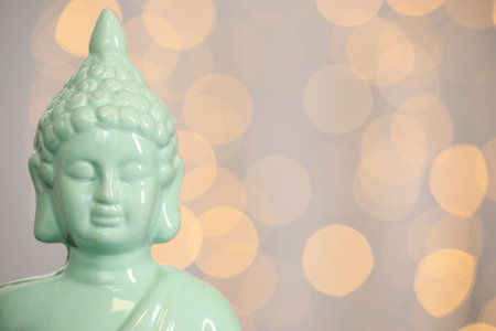 Buddha statue against blurred lights, closeup. Space for textの写真素材