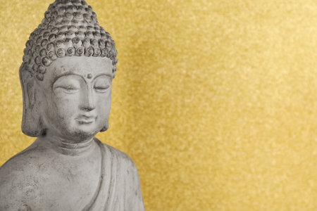 Buddha statue on golden background, closeup. Space for textの写真素材