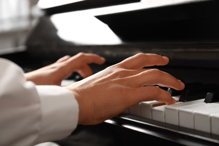 Young woman playing piano, closeup. music lessonsの写真素材