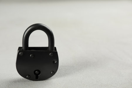 Vintage padlock on light table. Space for textの写真素材